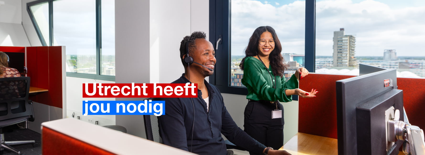 Twee medewerkers staan bij een computer en een persoon is aan het bellen. In beeld staat de tekst 'Utrecht heeft jou nodig'.